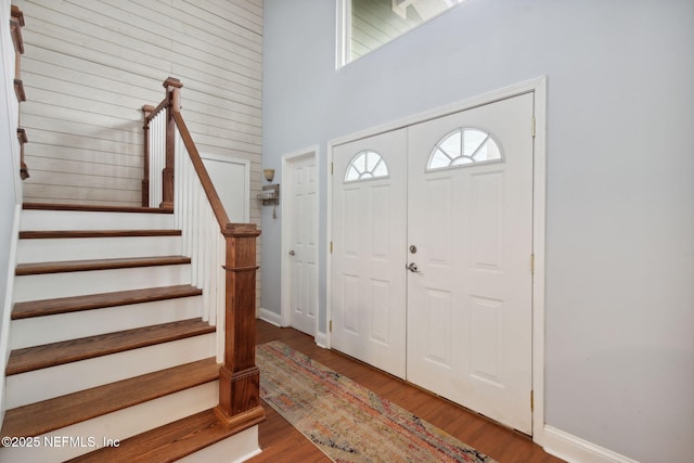 entryway with a high ceiling and light hardwood / wood-style flooring