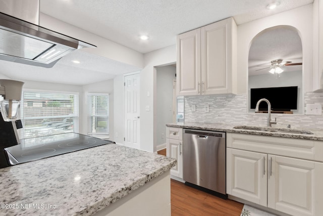 kitchen featuring stainless steel dishwasher, sink, a textured ceiling, and white cabinetry