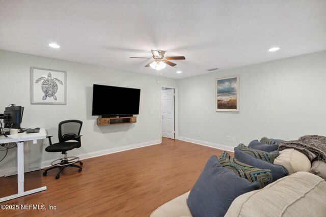 office space featuring ceiling fan, wood-type flooring, and a textured ceiling