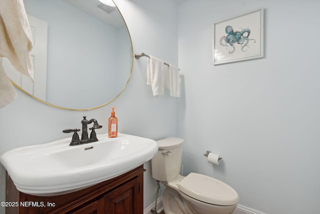 bathroom with toilet and vanity