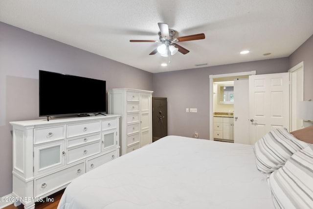 bedroom featuring a textured ceiling, ceiling fan, and ensuite bathroom