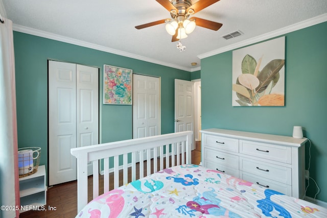 bedroom featuring ceiling fan, dark hardwood / wood-style floors, ornamental molding, and a textured ceiling