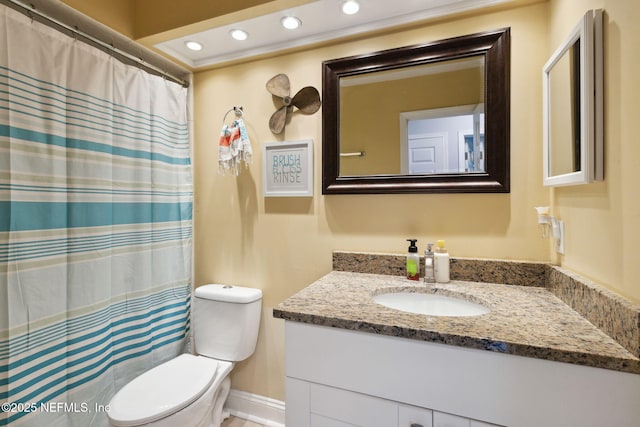 bathroom featuring toilet and vanity