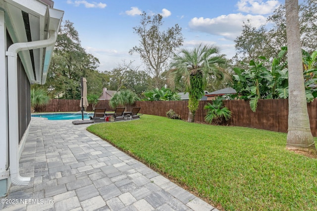 view of yard featuring a fenced in pool and a patio