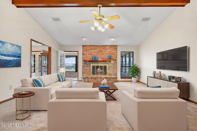 carpeted living room with a brick fireplace, high vaulted ceiling, beamed ceiling, and ceiling fan