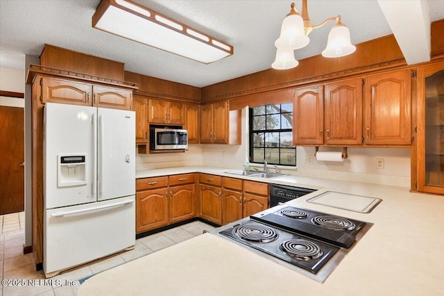 kitchen featuring light tile patterned floors, sink, black dishwasher, white fridge with ice dispenser, and decorative light fixtures