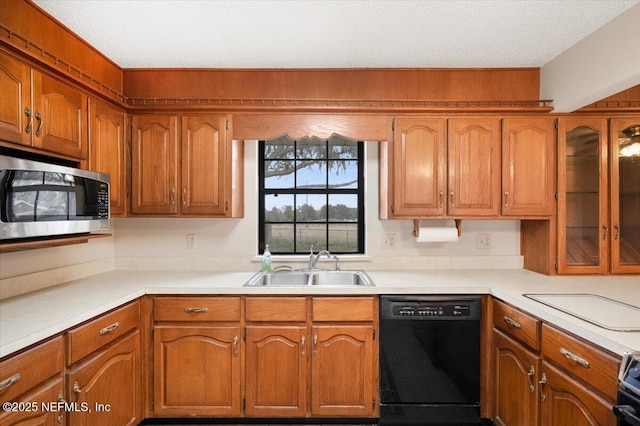 kitchen with dishwasher, sink, and a textured ceiling