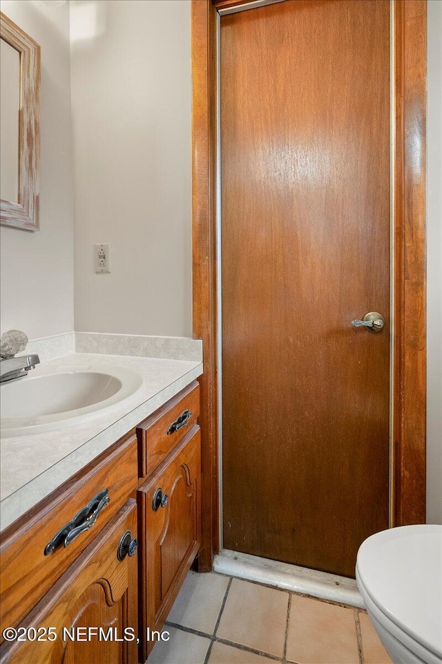 bathroom with tile patterned floors, toilet, and vanity