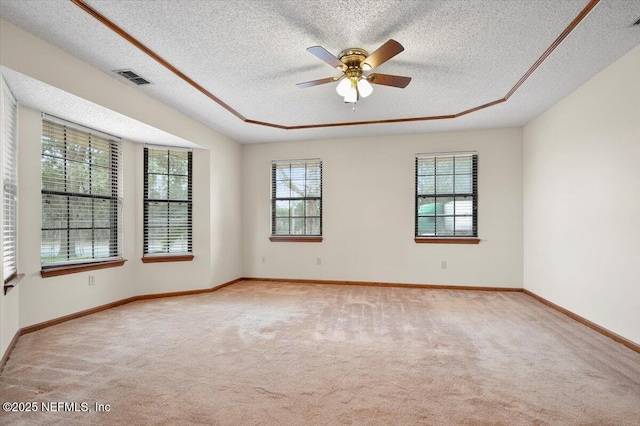 carpeted spare room with a textured ceiling and ceiling fan