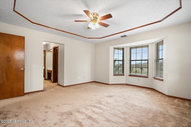 carpeted spare room featuring ceiling fan and a textured ceiling