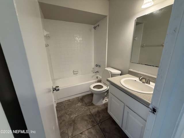 full bathroom featuring tiled shower / bath, vanity, toilet, and tile patterned floors