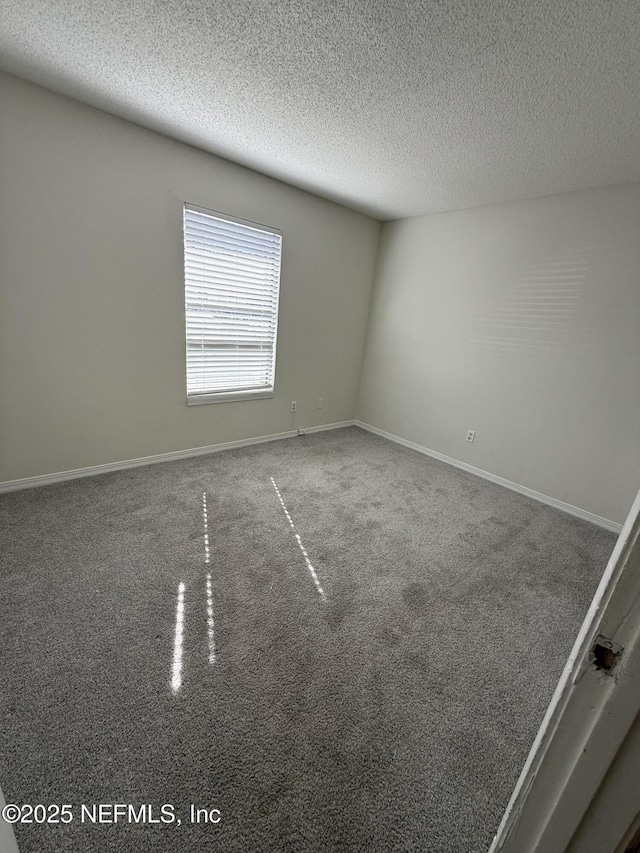 spare room with a textured ceiling