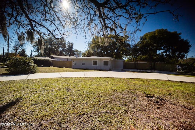 single story home featuring a garage and a front yard