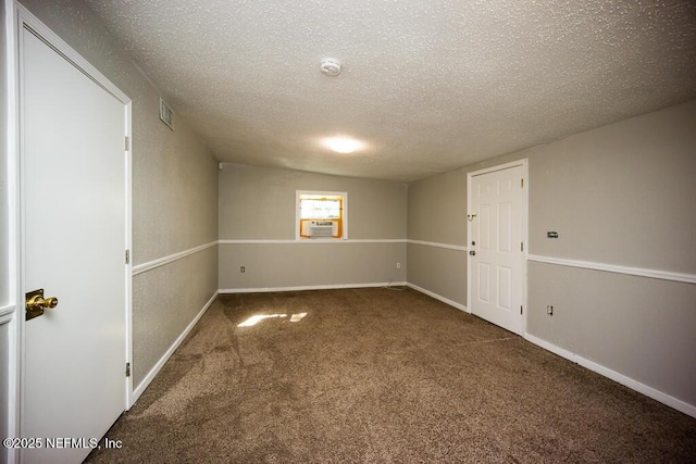 carpeted empty room with a textured ceiling and cooling unit