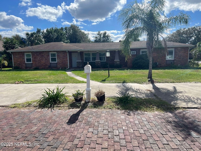 ranch-style home with a front lawn