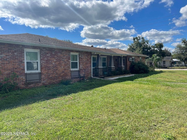 rear view of property with a lawn