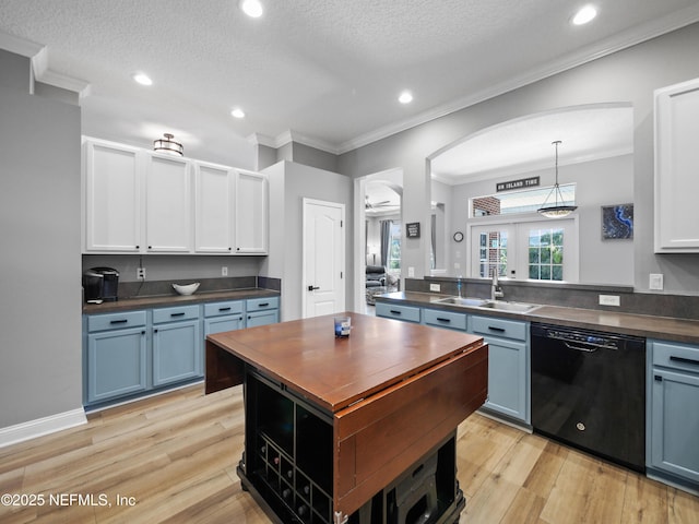 kitchen with sink, white cabinetry, a textured ceiling, dishwasher, and pendant lighting