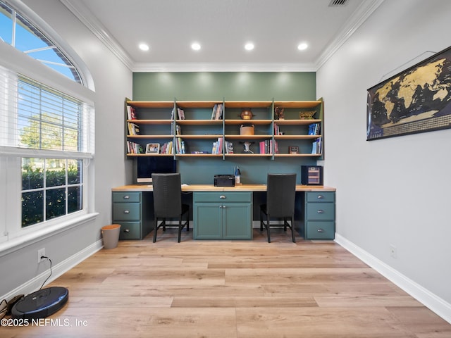 home office with ornamental molding and light hardwood / wood-style flooring