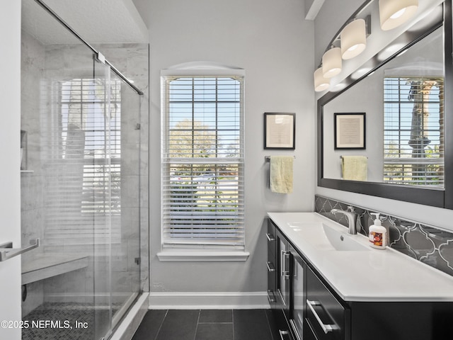 bathroom featuring a shower with door, plenty of natural light, and tile patterned floors