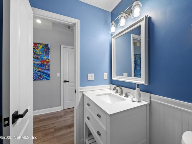 bathroom featuring vanity, wood-type flooring, and a textured ceiling