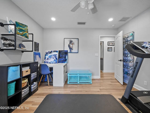 office space featuring ceiling fan, wood-type flooring, and a textured ceiling