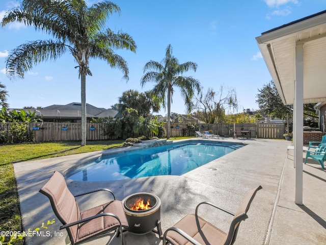 view of pool with a patio and a lawn