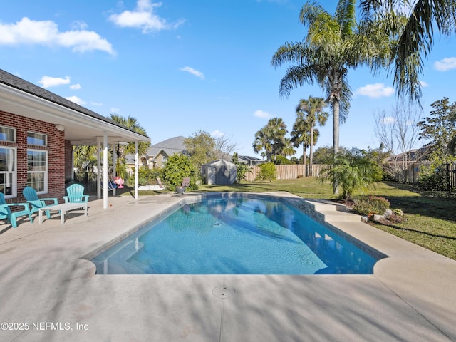 view of pool with a patio area and a lawn