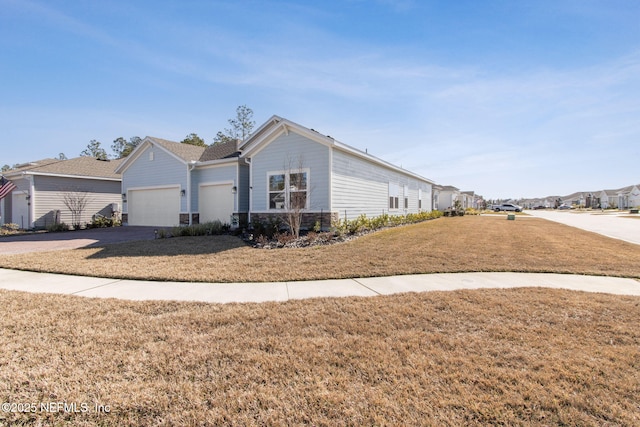 ranch-style home with a garage and a front yard