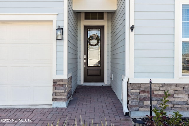 doorway to property with a garage