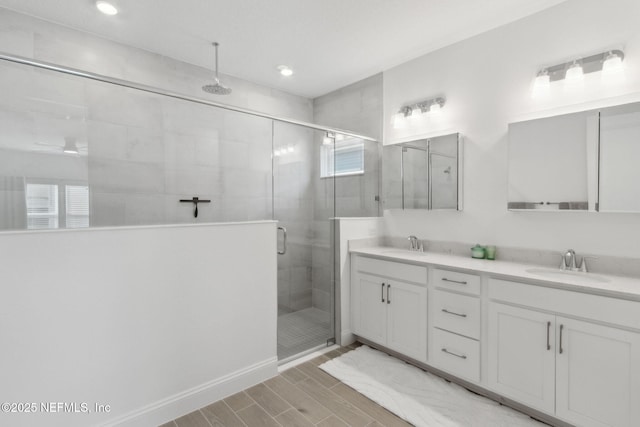 bathroom with an enclosed shower and vanity