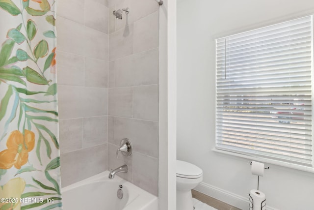 bathroom with toilet and shower / tub combo with curtain