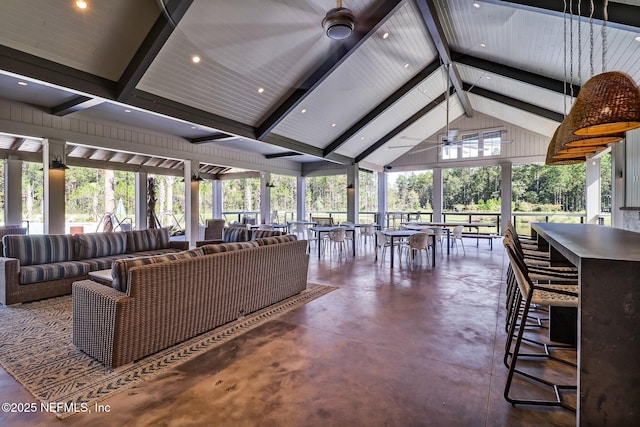 interior space featuring ceiling fan and vaulted ceiling with beams