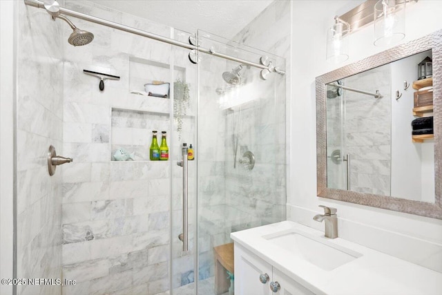 bathroom with vanity and a shower with shower door