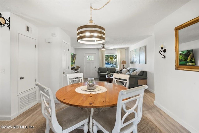 dining room with an inviting chandelier and light hardwood / wood-style floors