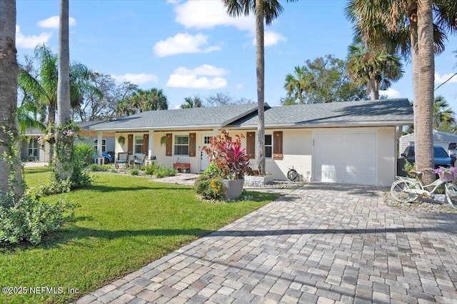 ranch-style house with a garage, covered porch, and a front lawn