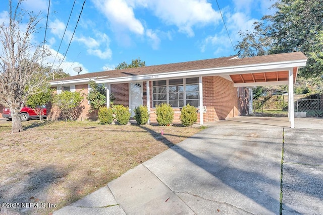 ranch-style home with a front yard and a carport