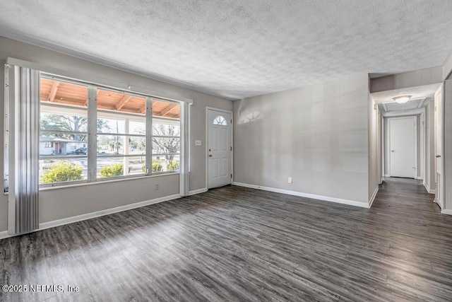 interior space featuring a textured ceiling and dark hardwood / wood-style flooring