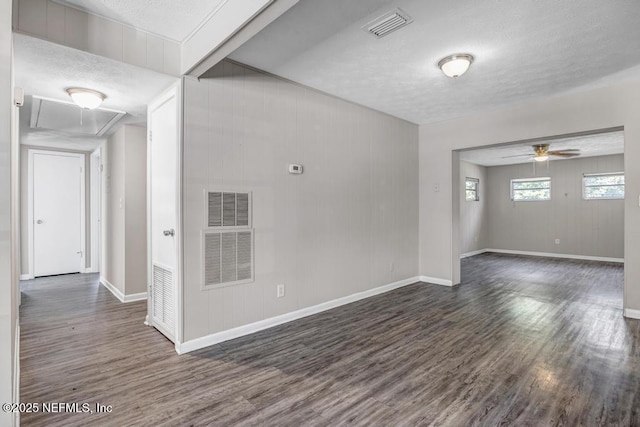 spare room featuring a textured ceiling, ceiling fan, and dark hardwood / wood-style flooring