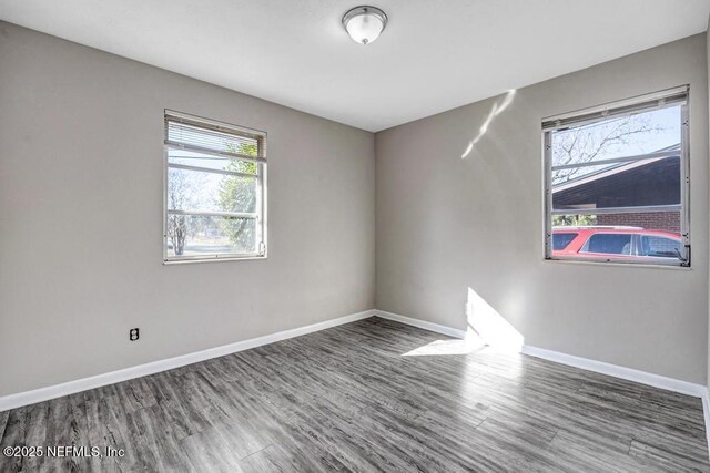 empty room featuring dark wood-type flooring