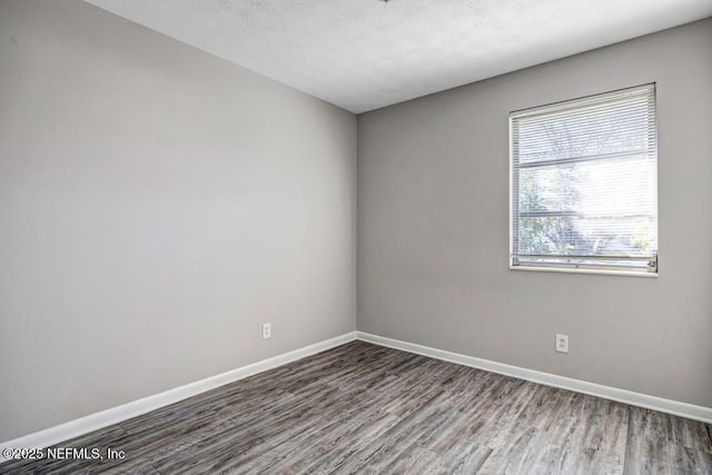 empty room with hardwood / wood-style floors