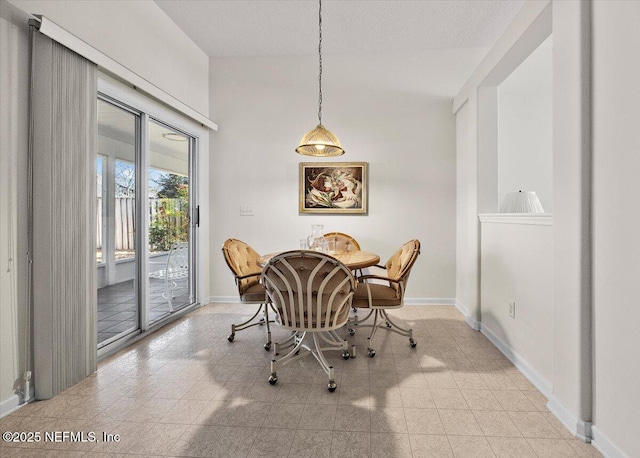 dining area featuring a textured ceiling