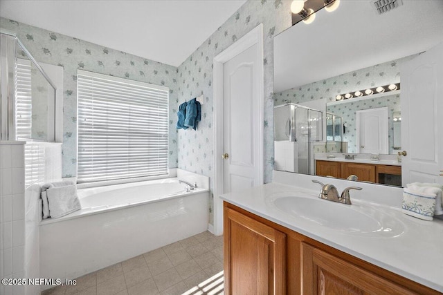 bathroom featuring tile patterned floors, vanity, and plus walk in shower