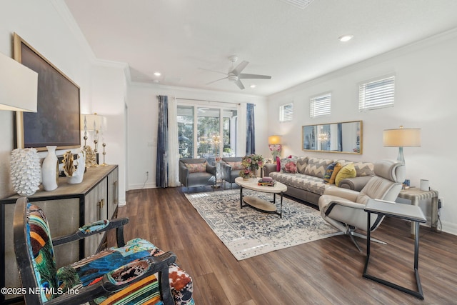 living room with crown molding, dark wood-type flooring, and ceiling fan