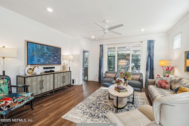 living room with crown molding, dark wood-type flooring, and ceiling fan