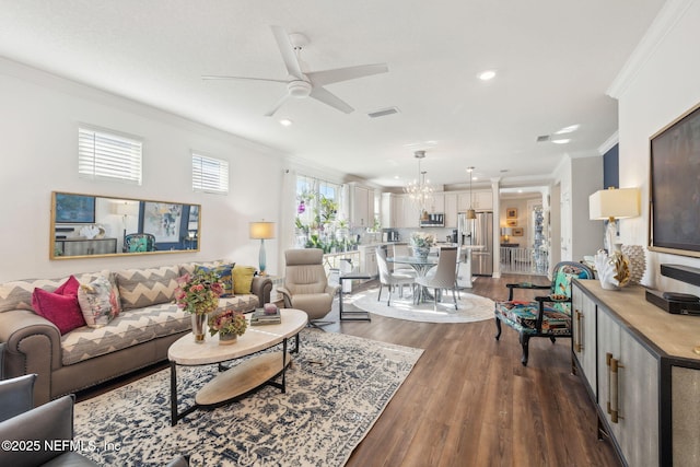 living room featuring crown molding, ceiling fan with notable chandelier, and dark hardwood / wood-style floors