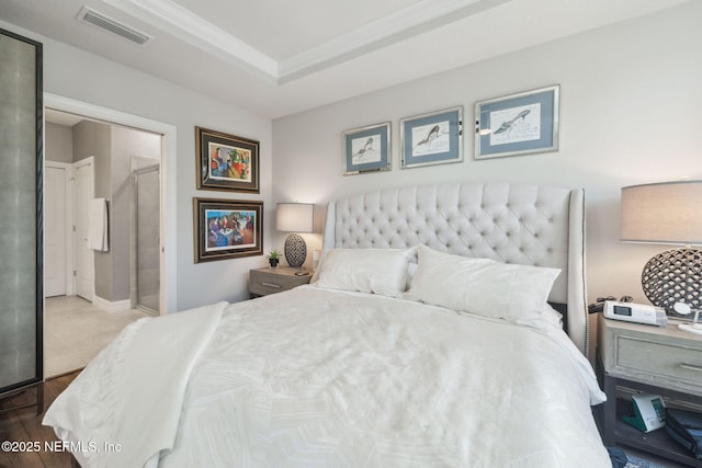 bedroom featuring hardwood / wood-style flooring and a raised ceiling