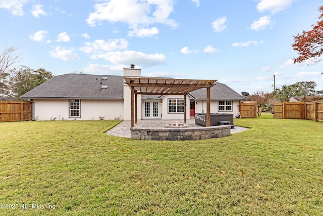 back of property with a patio, a pergola, a lawn, and a hot tub