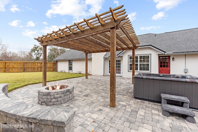 view of patio with an outdoor fire pit, a pergola, and a hot tub