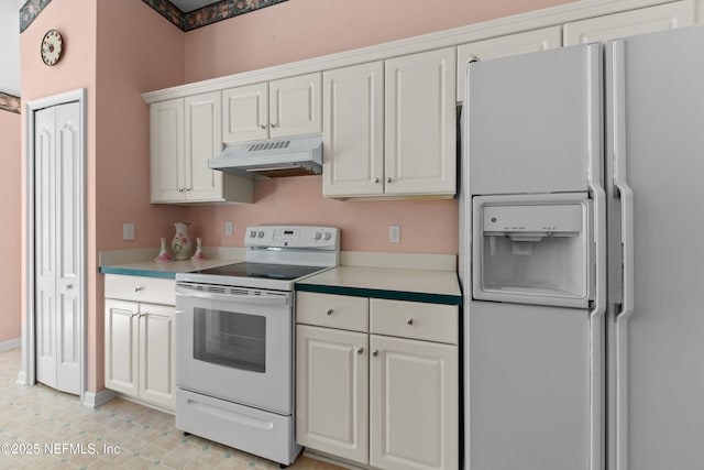 kitchen featuring white cabinetry and white appliances