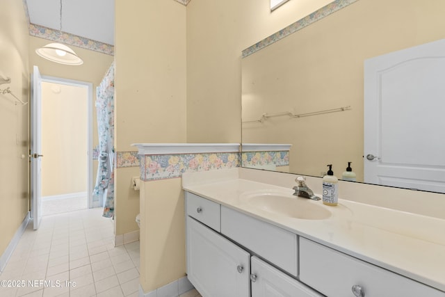 bathroom featuring vanity, tile patterned flooring, and toilet